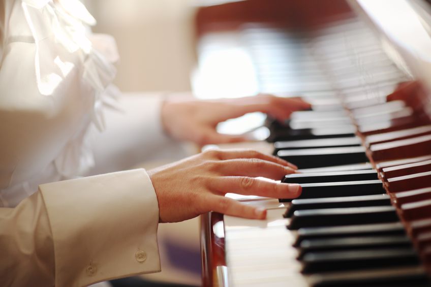 9067871 – female hands playing piano. closeup, shallow dof.